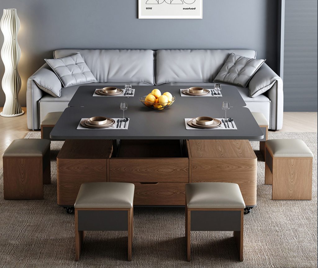 Modern multifunctional table transformed into a full dining table with six cushioned stools, grey tabletop, and complete place settings.
